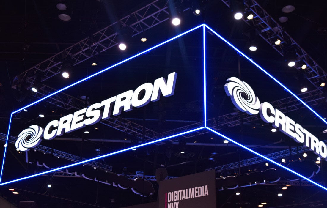 Crestron lighting up the exhibition hall with their neon blue sign.